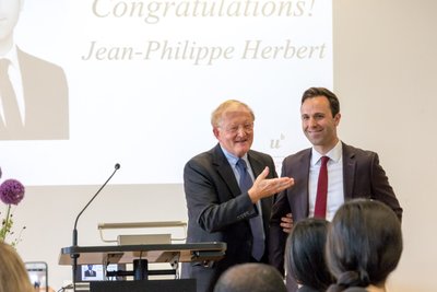 Thomas Cottier presenting the award to Jean-Philippe Herbert, graduate of MILE 17    