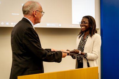 Prof Peter van den Bossche presenting the award to Stella Nalwoga from Uganda (MILE 21)    