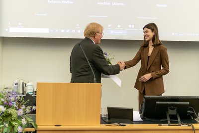 Thomas Cottier presenting the award to Marianna Henud Cresci, graduate of MILE 20    